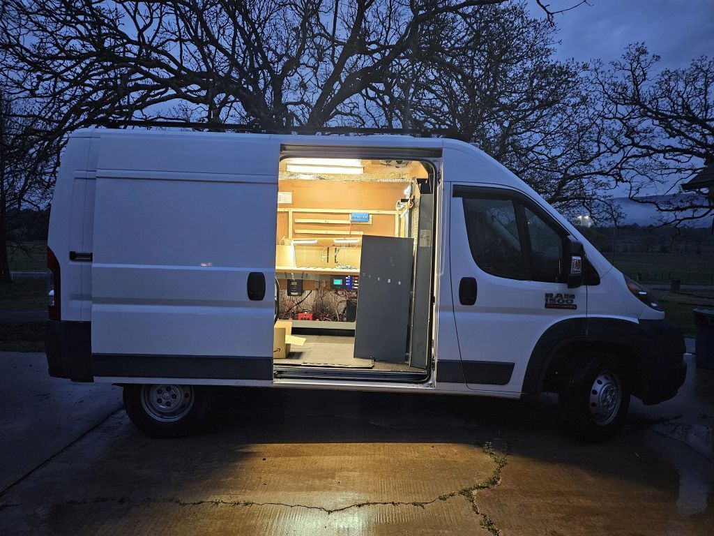 2016 Promaster 1500 136WB Cargo Bay Side Door Open showing lights in early morning 01